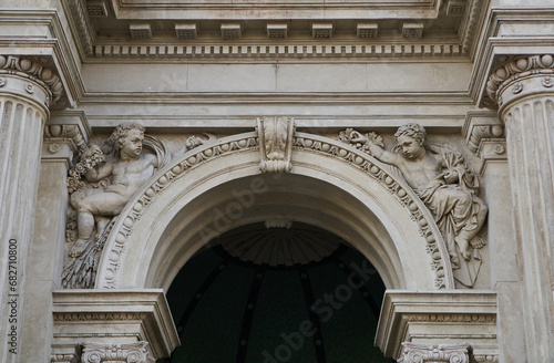 Stone arch of Varkert Bazar  Hungarian  V  rkert Bazaar or V  rbaz  r  decorated with columns and angels sculptures. Budapest  Hungary - 7 May  2019