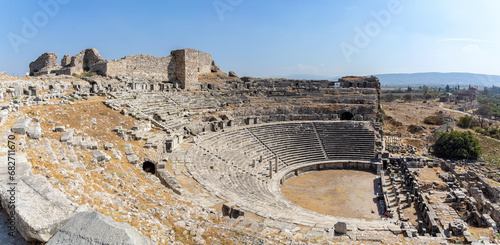 General view to the ancient theatre in Miletus with ruins of Byzantine castle. Aydin, Turkey