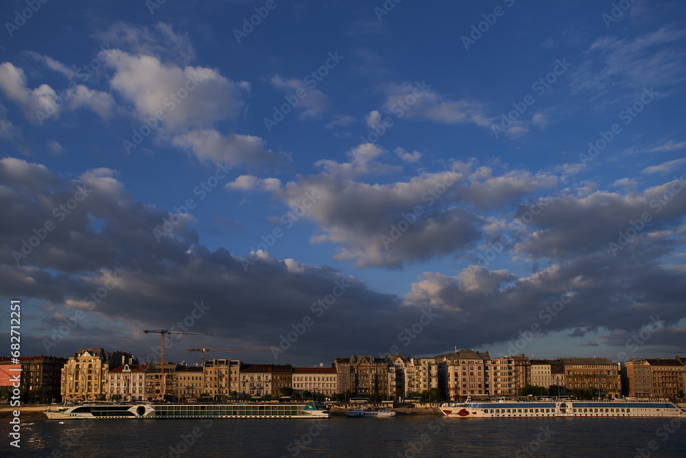 Fototapeta premium Beautiful panorama of Budapest waterfront on Danube river at sunset. Budapest, Hungary - 7 May, 2019