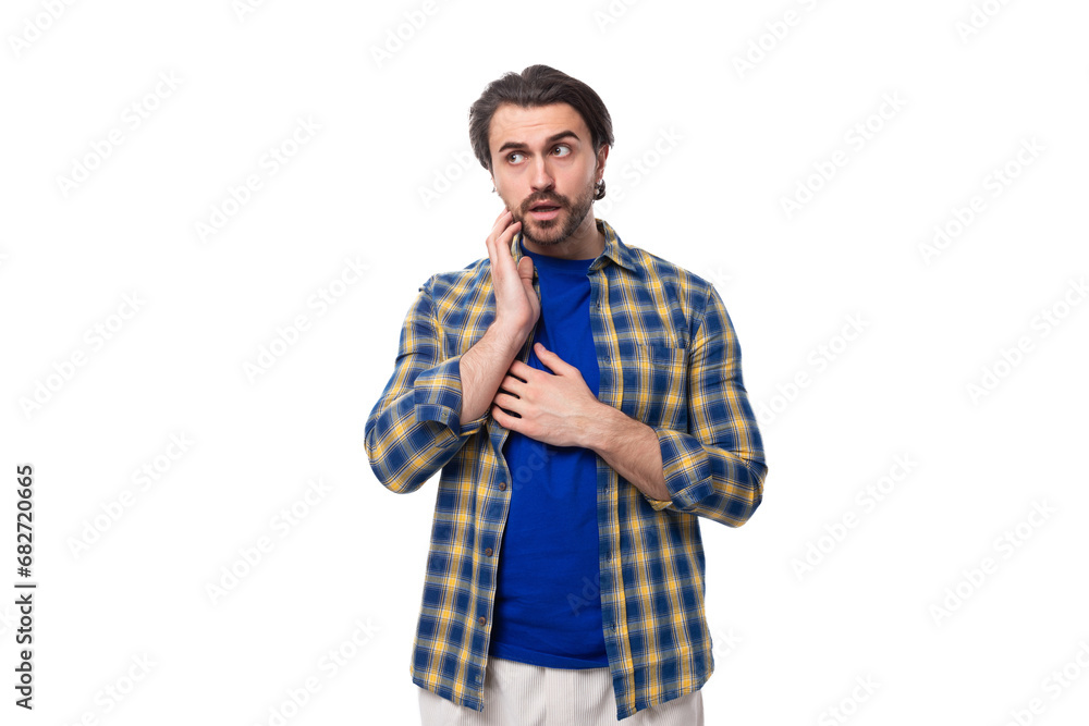 young caucasian brutal man with unshaven face dressed in a plaid stylish shirt young caucasian brutal man with unshaven face dressed in a plaid stylish shirt