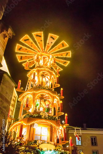 Traditional spinning Christmas pyramid lit up at night, at Christmas market in Basel, Switzerland