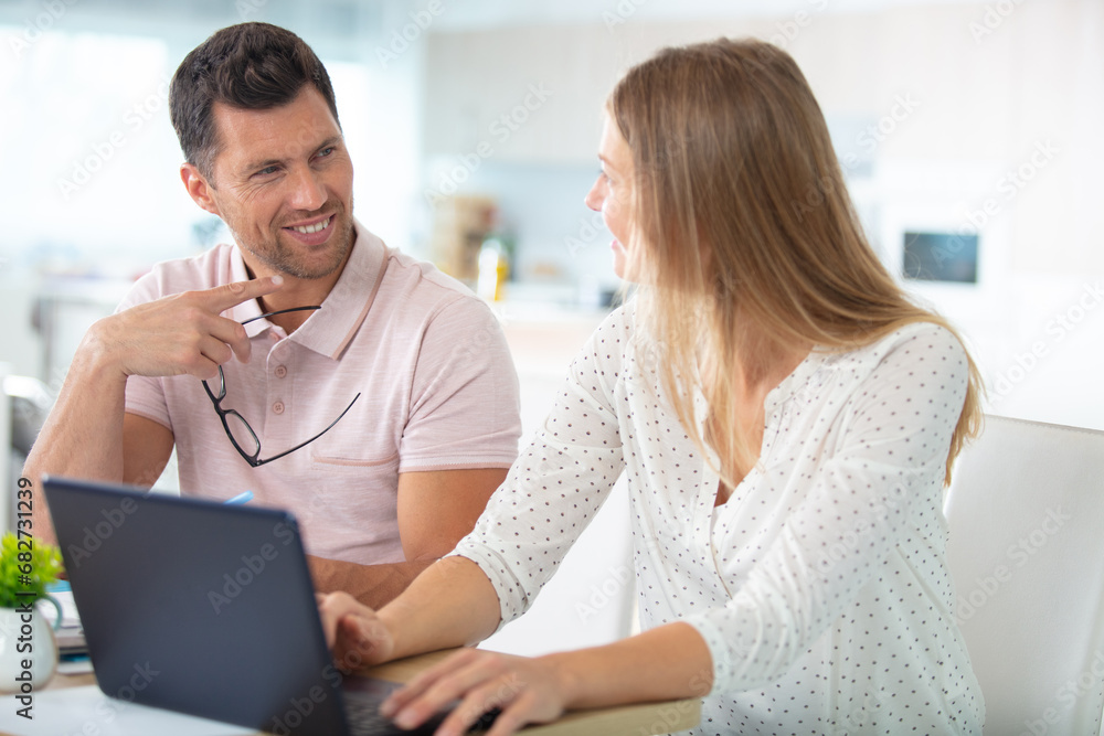 couple relaxing on sofa with digital tablet and laptop couple relaxing on sofa with digital tablet and laptop