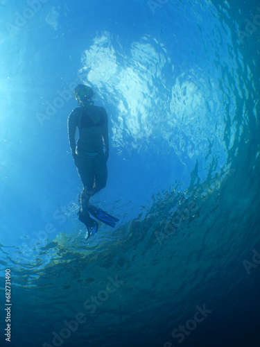 a woman snorkeling in the crystal clear waters