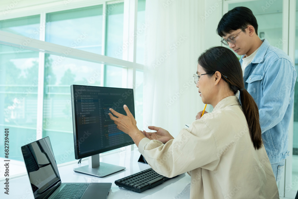 IT programmers working together at office desk. IT programmers working together at office desk.