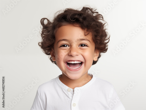 Beautiful little oriental boy laughing. Full mouth smile. Isolated on white background