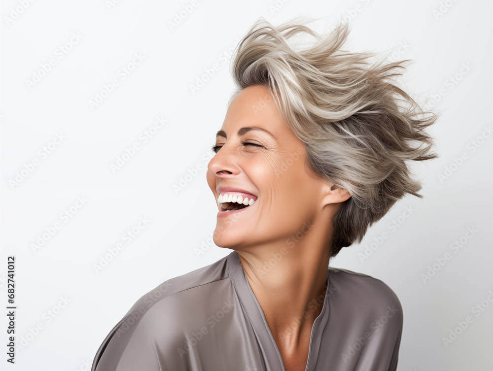 A beautiful middle-aged woman laughs. Full mouth smile. Isolated on white background
A beautiful middle-aged woman laughs. Full mouth smile. Isolated on white background