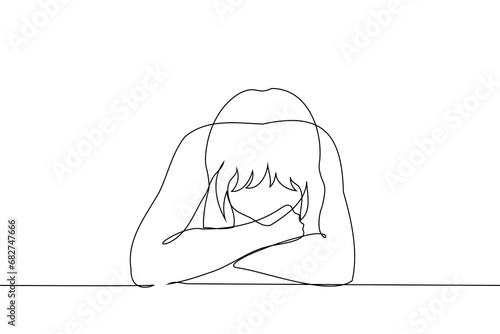 woman sits at the table with her head bowed on her crossed arms bent at the elbows - one line art vector. concept sadness, laziness, procrastination, burnout