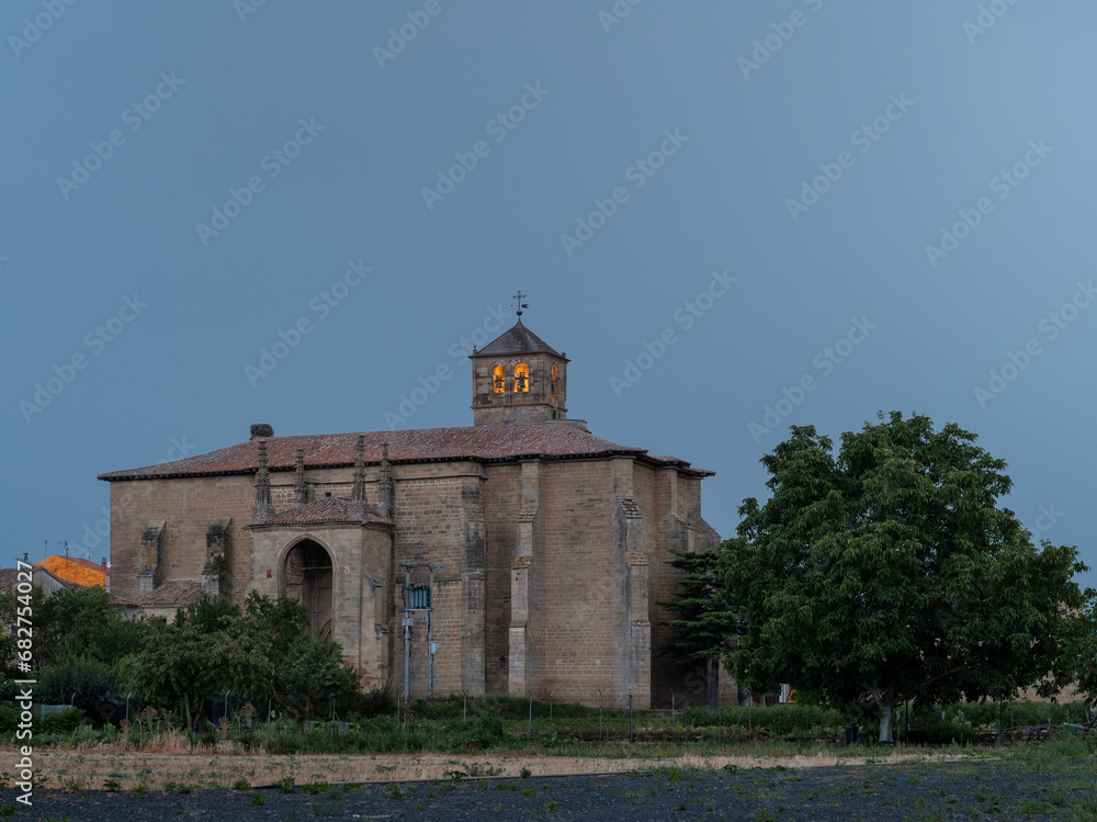 Santa Cruz (Holy Cross) church in small village of La Rioja, in the north of Spain. Old church at sunset, with illuminated bell tower