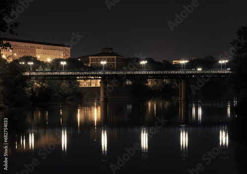 City bridge scene at Logrono  in the north of Spain. Night panoramic shot from iron bridge and Museum building in the background  over the river Ebro