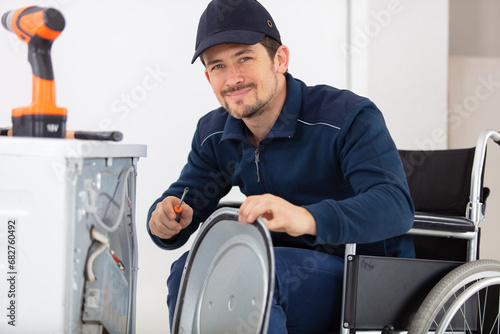 disabled handyman working with tools in workshop photo