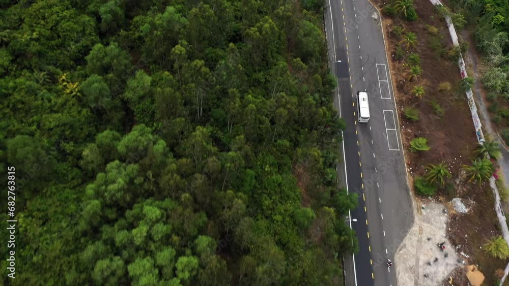 Drone, highway or forest and cars for landscape, street and nature background with transport or travel. Aerial view, trees and truck driving in road with environment, greenery or countryside location Drone, highway or forest and cars for landscape, street and nature background with transport or travel. Aerial view, trees and truck driving in road with environment, greenery or countryside location