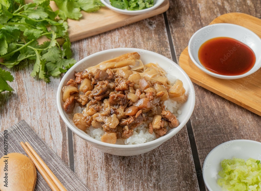 Pork rice with chilli sauce, noodles, spoon and chopsticks served in dish isolated on napkin top view of hong kong food