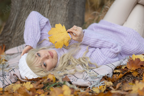 Happy beautiful young woman in casual clothes enjoying solitude while traveling through autumn forest outdoors in autumn, selective focus