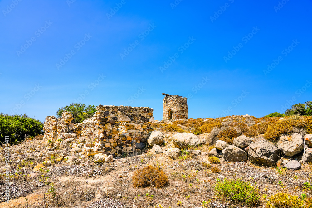 Landscape on the Greek island of Kos with a ruin of an old windmill.
