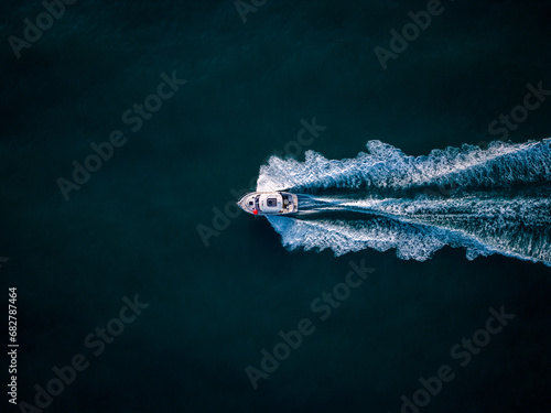 Aerial view of speed motor boat on open blue sea © sandsun