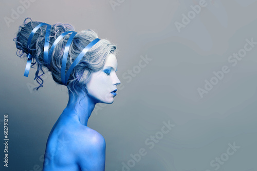 Winter cool cold woman with blue and white body art, carnival makeup and hairstyle