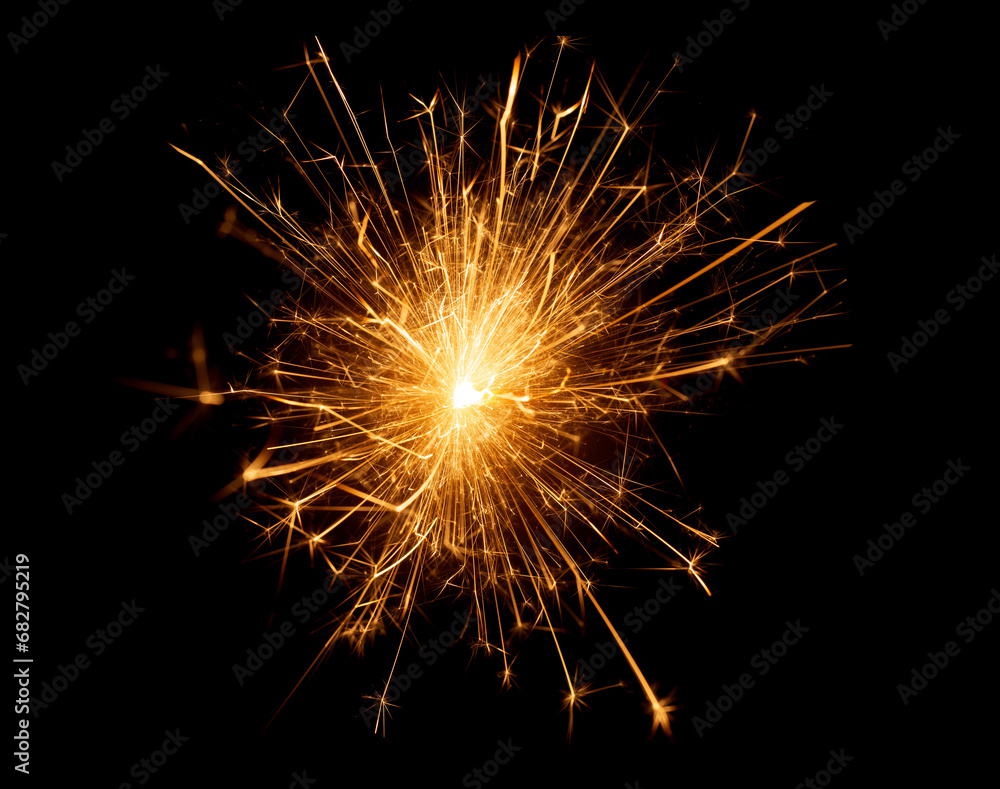 close up of burning sparkler against black background