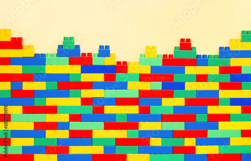 Creative Wall on yellow background: Constructible Toy Bricks for Imaginative Kids. Educational toys for kids. Colorful plastic brick blocks. Education, children's creativity