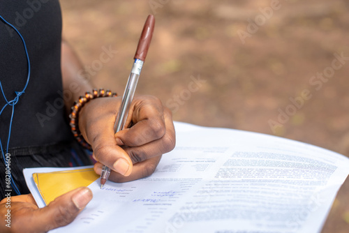 Oyo, NIGERIA - Novemebr 09, 2023: A lady fills a form photo