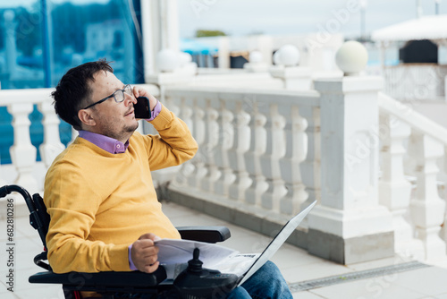 A person with disabilities with a laptop and a phone