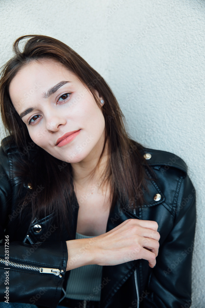 Portrait of a brunette woman with emotions on a light background Portrait of a brunette woman with emotions on a light background