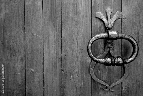 Old metal door handle in black and white.