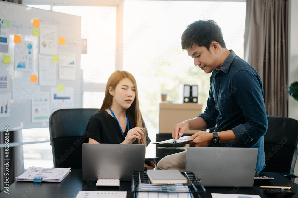 Furious two Asian businesspeople arguing strongly after making a mistake at work in office.. Furious two Asian businesspeople arguing strongly after making a mistake at work in office..