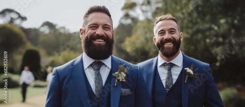 Handsome couple bearded groom and groomsman smiling at outdoors background photo
