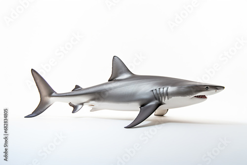 a toy shark with a toothy face and sharp teeth