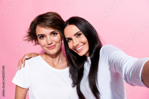 Photo of cute lovely pretty girls wear white trendy clothes recording video live stream isolated on pink color background