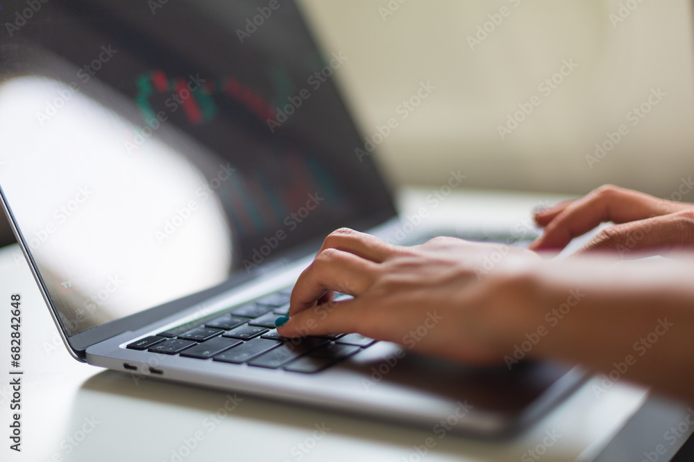 Woman working and looking at graphs Woman working and looking at graphs