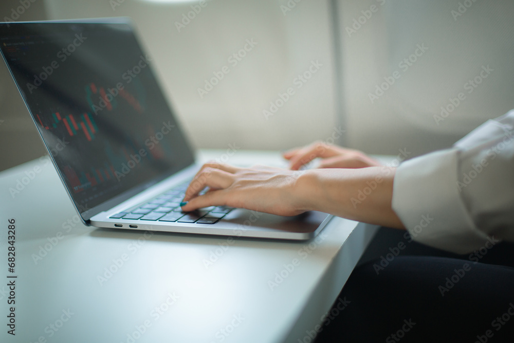 Woman working and looking at graphs Woman working and looking at graphs