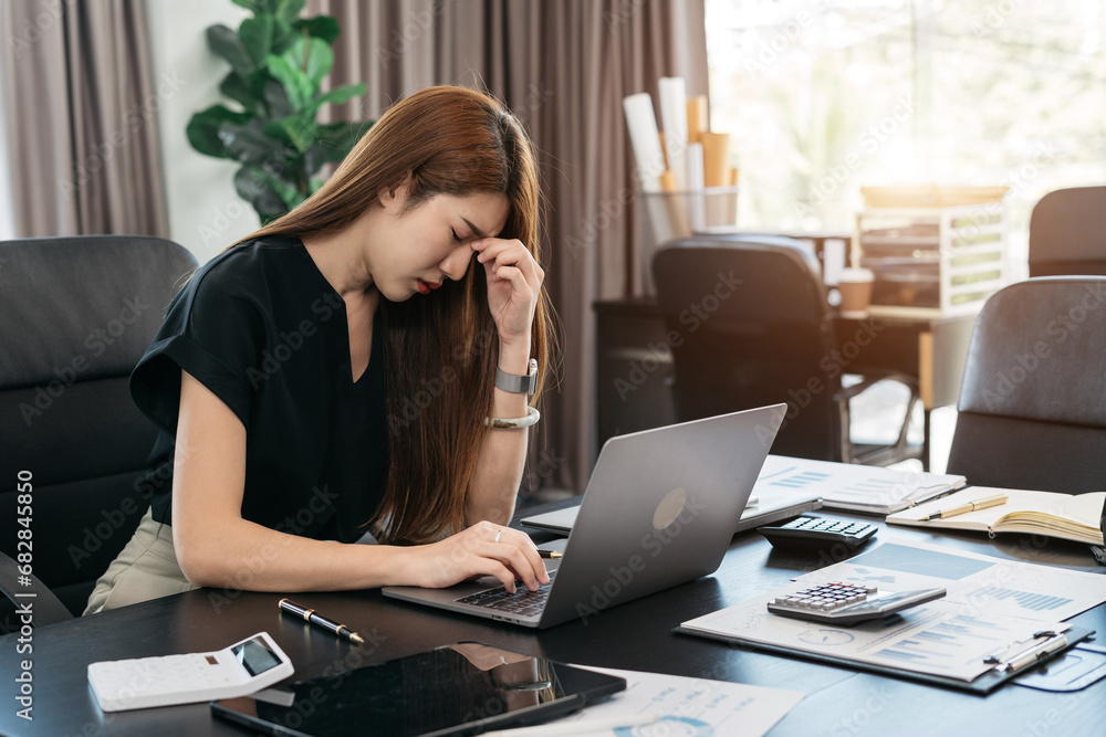 young asian businesswoman cover her face after stressed with Financial problem, credit card debt. young asian businesswoman cover her face after stressed with Financial problem, credit card debt.