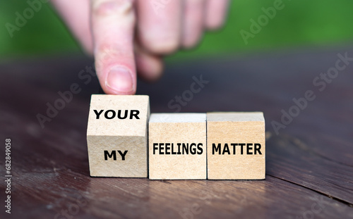 Hand turns wooden cubes and change the expression 'my feelings matter' to 'your feelings matter'.
