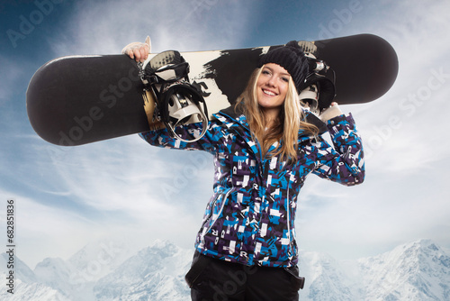 Positive beautiful young girl with a snowboard photo