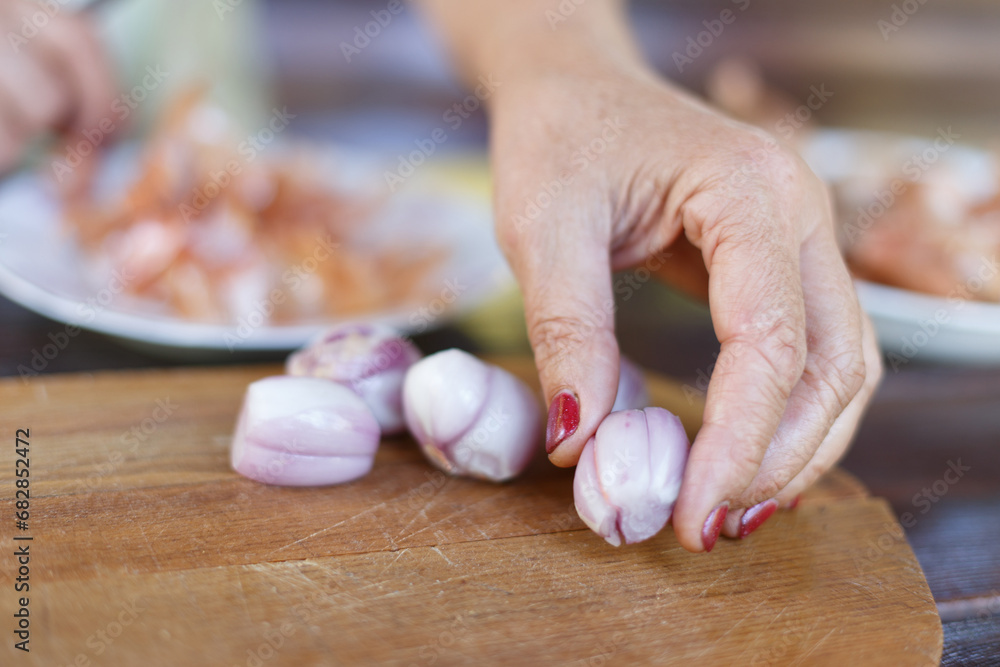 Peeled onions laid out by a woman on a board Peeled onions laid out by a woman on a board