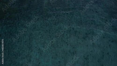Top down aerial view of crashing ocean waves, drone is flying towards deep water. Gili Trawangan Island, Lombok. High quality 4k footage photo