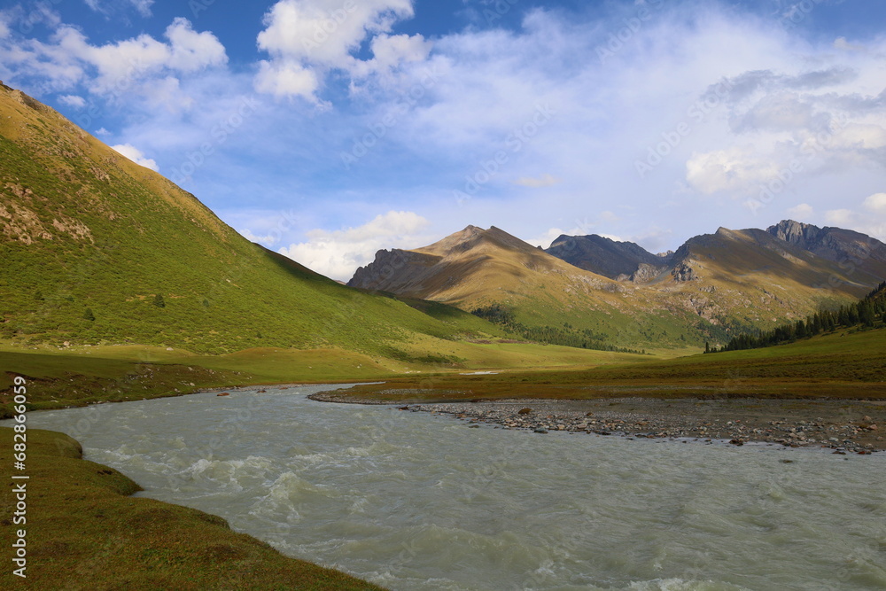 Ak-Suu river wading on fifth stage of Ak-Suu Traverse trek in Tian Shan mountains, Karakol, Kyrgyzstan