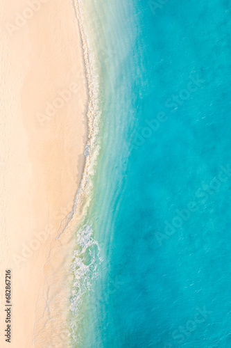 Relaxing aerial beach scene. Summer vacation holiday destination banner. Waves surf crash amazing blue ocean lagoon, sea shore, coastline. Perfect aerial drone top view. Peaceful bright beach, seaside
