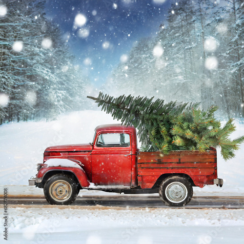 Classic old red pick up truck with a Christmas tree on a country road 