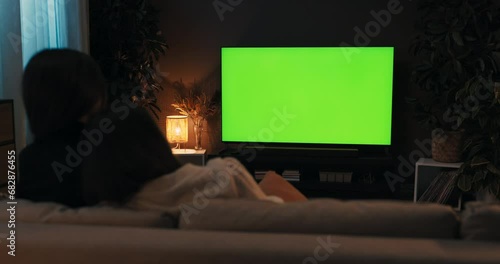 Women lovely lesbian homosexual couple sitting in the living room friends watching tv. White screen mockup concept at cozy home.