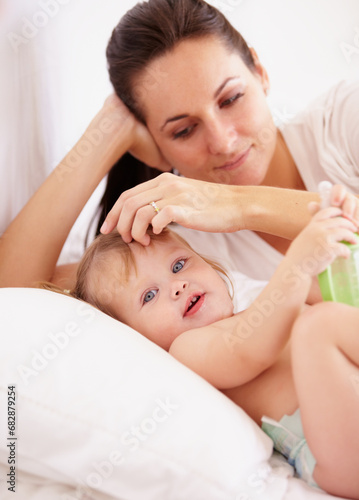 Baby, mother and portrait or smile on bed with bottle, relax and parenting in bedroom of home with security. Family, woman or girl kid with happiness in nursery for development, love or care in house