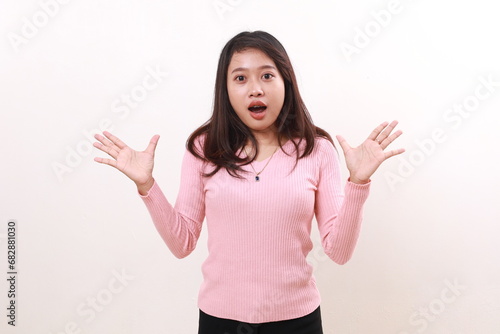 Wow shocked young asian girl standing while showing surprised reaction face. Isolated on white