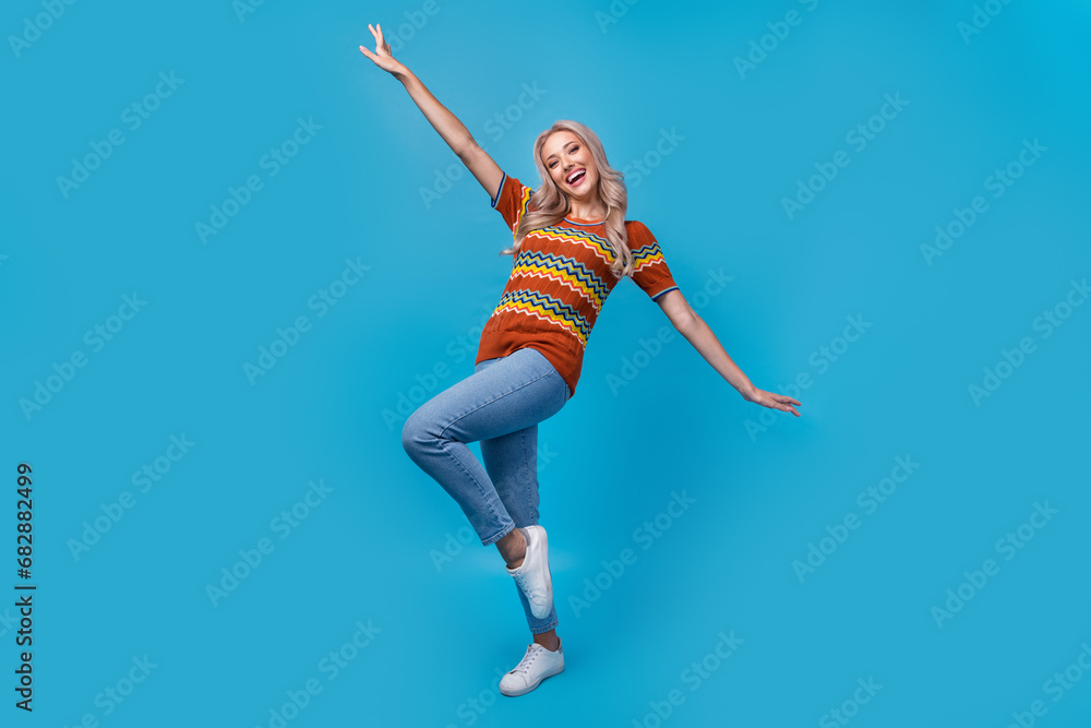 Full length photo of adorable carefree lady wear print shirt dancing having fun isolated blue color background