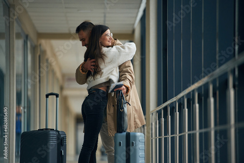 Farewell, embracing each other. Couple are in the airport hall together photo