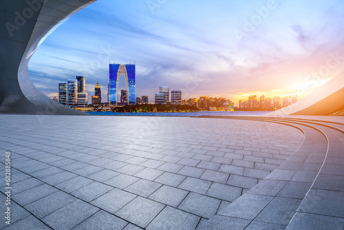 City square and skyline with modern buildings at sunset in Suzhou, Jiangsu Province, China. photo