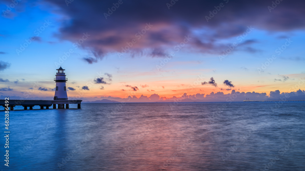 Beautiful coastline and lighthouse building landscape at sunrise in Zhuhai, Guangdong Province, China. Panoramic view.