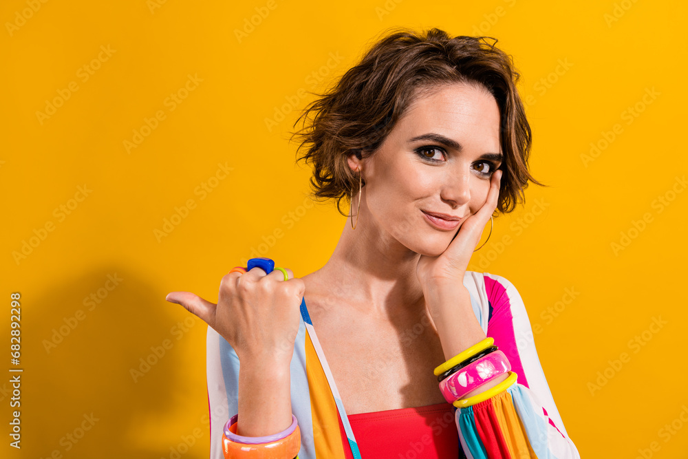 Photo of carnival costume young girl touch cheekbone indicate finger empty space retro outfits store isolated on yellow color background Photo of carnival costume young girl touch cheekbone indicate finger empty space retro outfits store isolated on yellow color background