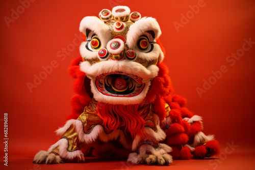 A traditional Chinese new year lion dance dragon costume against a red background © ink drop