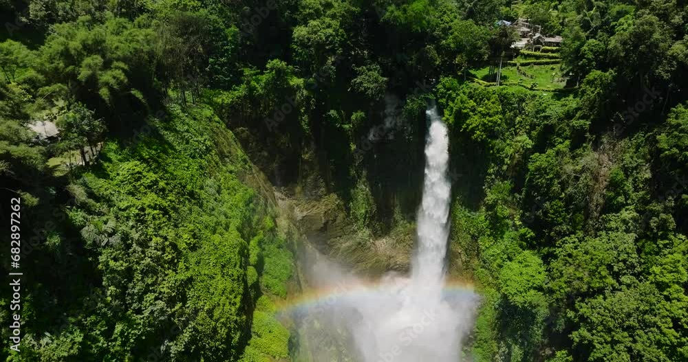 Beautiful waterfall in the jungle of Lake Sebu. A stream of waterfalls from high rocks, splitting into streams, creating mist. Rainbow. Mindanao, Philippines. Beautiful waterfall in the jungle of Lake Sebu. A stream of waterfalls from high rocks, splitting into streams, creating mist. Rainbow. Mindanao, Philippines.